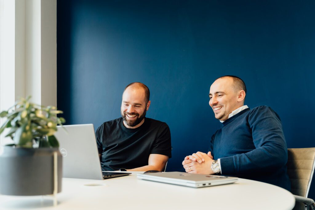Staff smiling while reviewing digital work