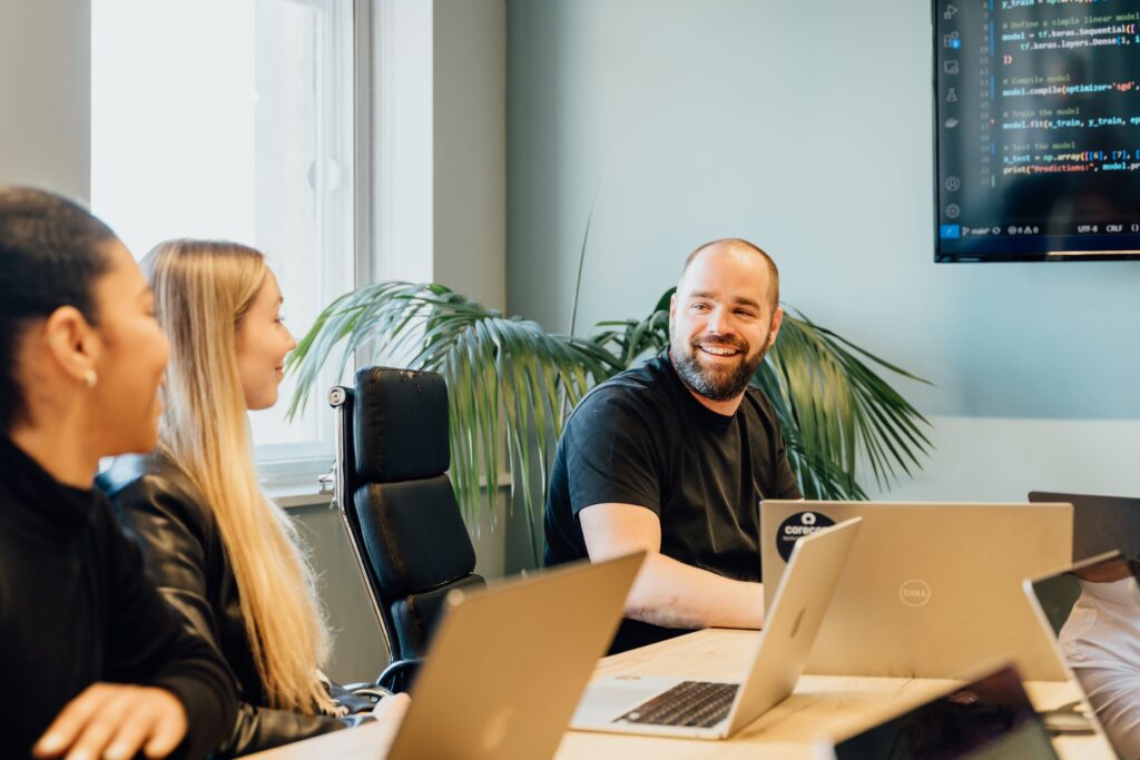 Thomas grinning at colleagues